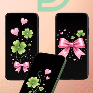 Könnte beinhalten: Drei Smartphones mit schwarzen Bildschirmen, die dekorative Designs zeigen. Die Designs umfassen rosa Schleifen, Herzen und grüne Kleeblätter. Das Telefon unten hat ein grünes Gehäuse, die anderen sind schwarz.