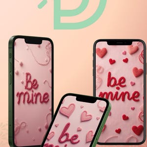 May include: Three smartphones with green cases display a pink background with embroidered hearts and the words "Be mine." The phones are arranged at different angles, showcasing the design. The background is a light pink color with a decorative design.