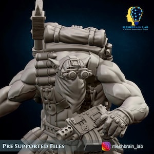 May include: A gray 3D-printed figurine of a muscular character, equipped with a backpack, goggles, and a machine gun. The figure has a bandana covering the lower face. Text at the bottom reads "PRE SUPPORTED FILES". The MeshBrain Lab logo is in the upper right corner.