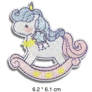 May include: Embroidered patch of a rocking horse unicorn. The unicorn has a white body, blue mane, and pink tail. The rocking base is pink with yellow stars. The patch measures 6.2 x 6.1 cm.