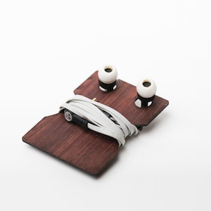 Wooden Ear Bud holder designed to keep your ear buds from tangling and for easy storage.