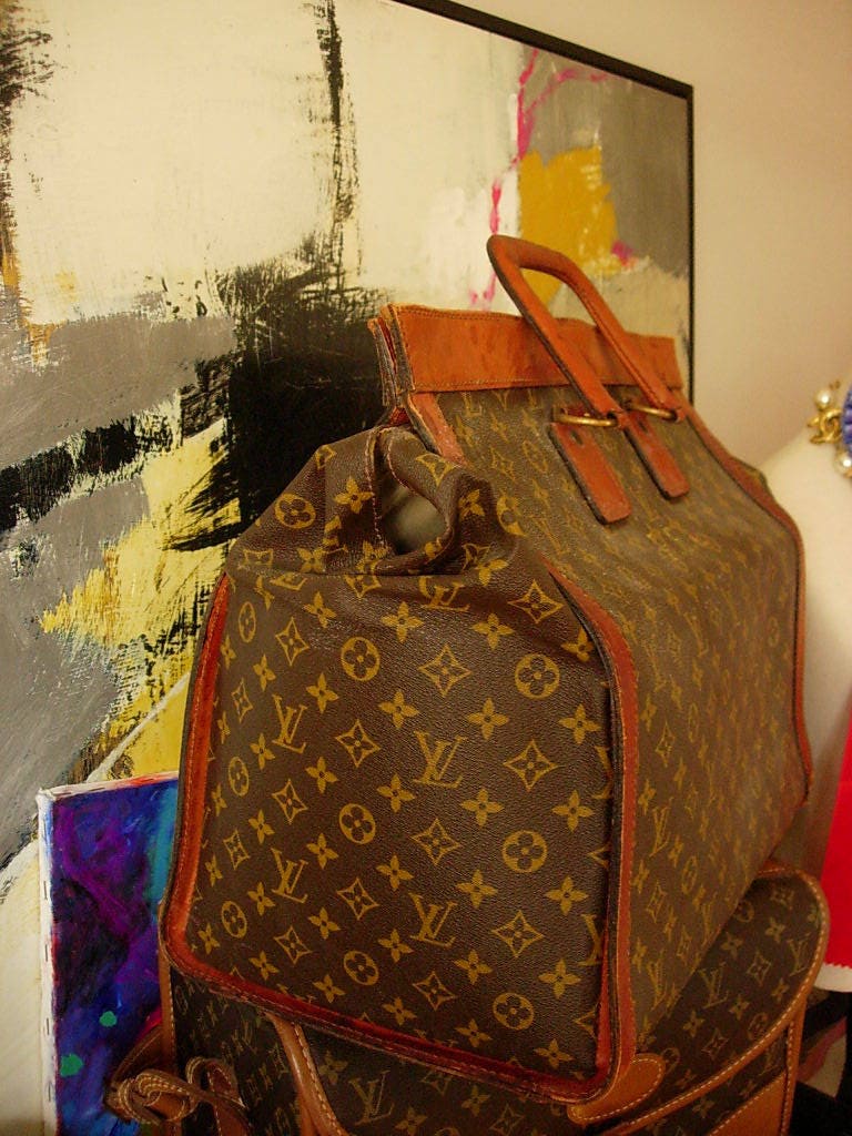 1950s Louis Vuitton suitcase, with leather strap work and canvas lined  aluminium frame, 70cm wide x