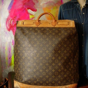 Vintage Louis Vuitton garment bag suitcase for suits with LV monogram. ht.  40in., wd. 22in. sold at auction on 15th July