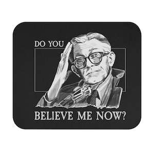 May include: Black and white illustration of a man wearing glasses and a suit, holding his head with one hand. The text "DO YOU" is above the man's head, and "BELIEVE ME NOW?" is below.