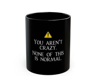 You Aren't Crazy None of This Is Normal mug | Black Ceramic Coffee Mug