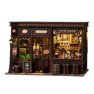 May include: A detailed miniature wooden tavern with the sign "The Hidden Tavern - In The Corner." The shop features a bar, bottles, glasses, and a small sign that says "Wine Shop." A small sign reads "Sample Text."
