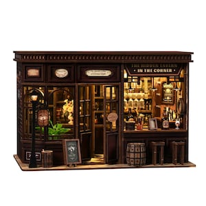 May include: A detailed miniature wooden tavern, labelled "The Hidden Tavern - In The Corner." The facade includes windows, a door, and a street lamp. Inside, a bar is visible, stocked with bottles and glasses, and a small barrel is present.
