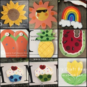 May include: A collage of painted wooden signs featuring summer themes. The signs include a sunflower, a sun wearing sunglasses, a rainbow, flip flops, a pineapple, a watermelon, a cupcake, and a tulip.