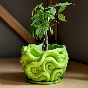 May include: A bright green plant pot featuring a swirling, wave-like pattern. The pot contains a small tree with a braided trunk and vivid green leaves. The pot rests on a matching saucer, creating a decorative display for indoor plants.