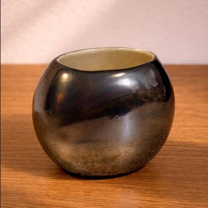 May include: A set of three ceramic mugs with a speckled, matte finish. The mugs are in shades of cream, light gray, and dark gray. Each mug has a simple, minimalist design, perfect for coffee or tea.