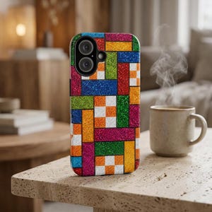 May include: A smartphone case featuring a vibrant, multi-colored geometric pattern composed of glittery rectangular and square blocks in shades of red, blue, green, orange, yellow, and magenta, with a circular cutout for the dual camera lens.