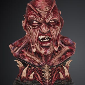 May include: A detailed bust of a creature with deep red, fleshy, and textured skin. The figure features a snarling expression, sharp white teeth, and pale yellow eyes. The base is adorned with protruding bone-like spikes and intricate, vein-like structures.