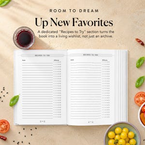 May include: An open recipe journal with two pages titled Recipes to Try, featuring lined columns for names and difficulty ratings. The text Room to Dream Up New Favorites and a description of the section are visible above the book, alongside a glass of red wine, tomato slices, and yellow cherry tomatoes.