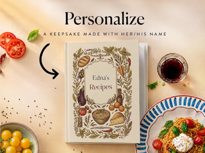 May include: A hardcover recipe book with a cream-colored cover featuring a botanical border of herbs, vegetables, and bread. The text reads "Personalize", "A KEEPSAKE MADE WITH HER/HIS NAME", and "Edna's Recipes". A black arrow points to the book.