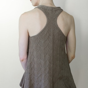 May include: A brown sleeveless knit top with a geometric pattern. The top has a scoop neck and a loose fit.