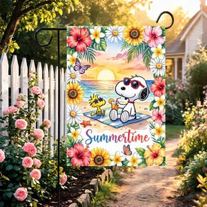 May include: A rectangular garden flag featuring a cartoon dog and a small yellow bird wearing sunglasses on a beach at sunset. The scene is framed by colorful hibiscus, sunflowers, and daisies. The text Summertime is written in blue script.