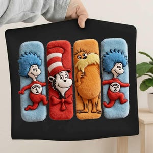 May include: Black pillow featuring four Dr. Seuss characters: Thing 1, The Cat in the Hat, The Lorax, and Thing 2. The characters are in a rectangular design with a blue, red, and orange color scheme.