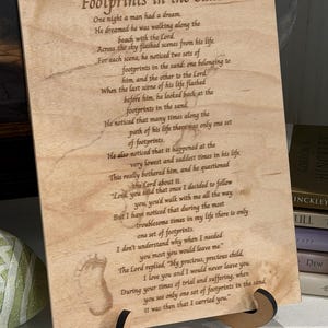 May include: A white ceramic mug with a black handle and the text "But First, Coffee" in a black, handwritten-style font. The mug is on a white surface.