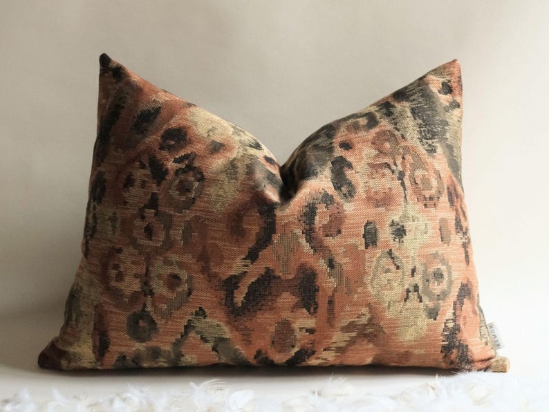 Rectangular designer throw pillow with rust, olive and dark abstract pattern, ideal for bedroom or living room decor
