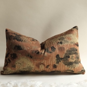 Lumbar decorative throw pillow with earthy terracotta, brown and olive woven pattern for modern bedroom decor