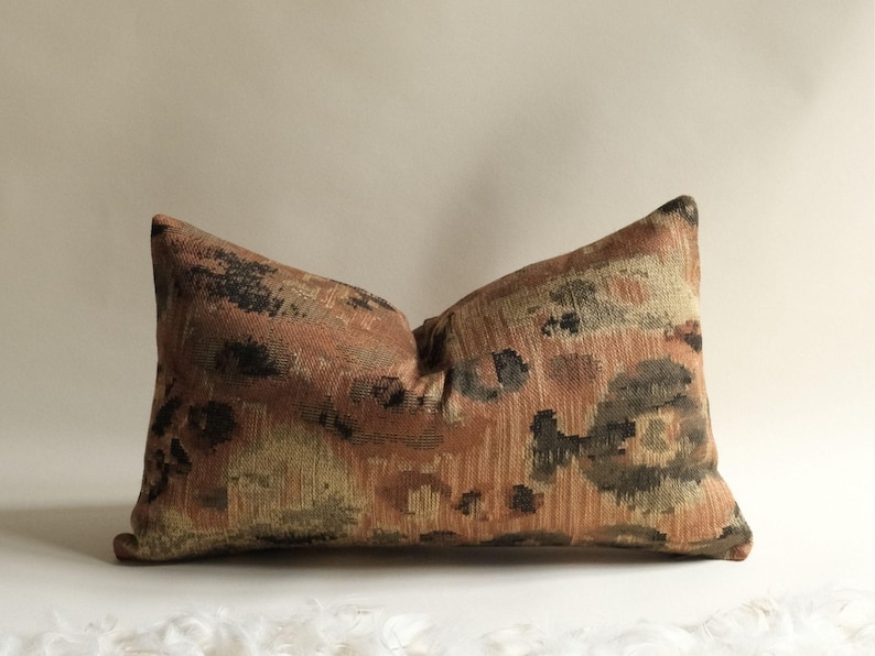 Lumbar decorative throw pillow with earthy terracotta, brown and olive woven pattern for modern bedroom decor