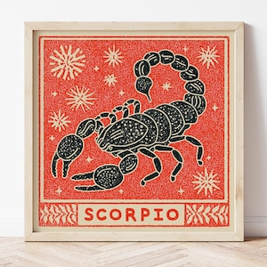 May include: A framed square print featuring a black scorpion illustration centred on a vibrant red background with white starburst accents. The word SCORPIO is printed in bold black capital letters within a rectangular border at the bottom.