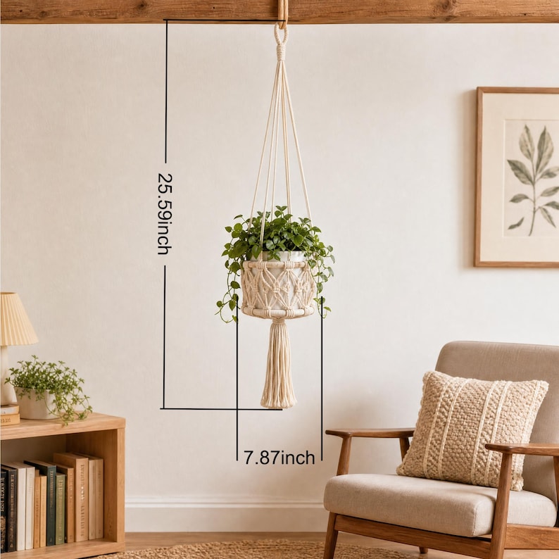 May include: A macrame plant hanger with a white ceramic pot filled with green plants. The hanger is suspended from a wooden beam. The overall height is 25.59 inches, and the width is 7.87 inches.