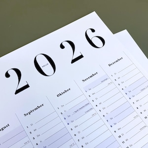 Könnte beinhalten: Ein weißer Kalender für 2026 mit dem Wort "HELLO" in der Null. Die Monate August, September, Oktober, November und Dezember sind sichtbar. Der Kalender hat ein minimalistisches Design mit schwarzem Text.