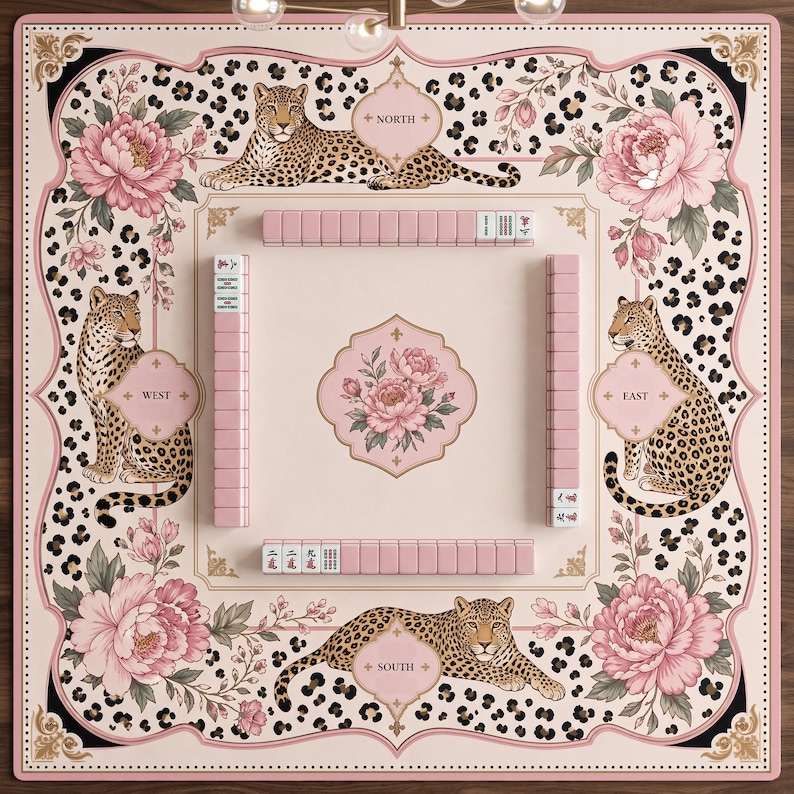 May include: A square mahjong mat featuring a pale pink background with a leopard print border, large pink peony illustrations, and four leopards positioned at the North, South, East, and West compass points. Pink mahjong tiles are arranged in rows.