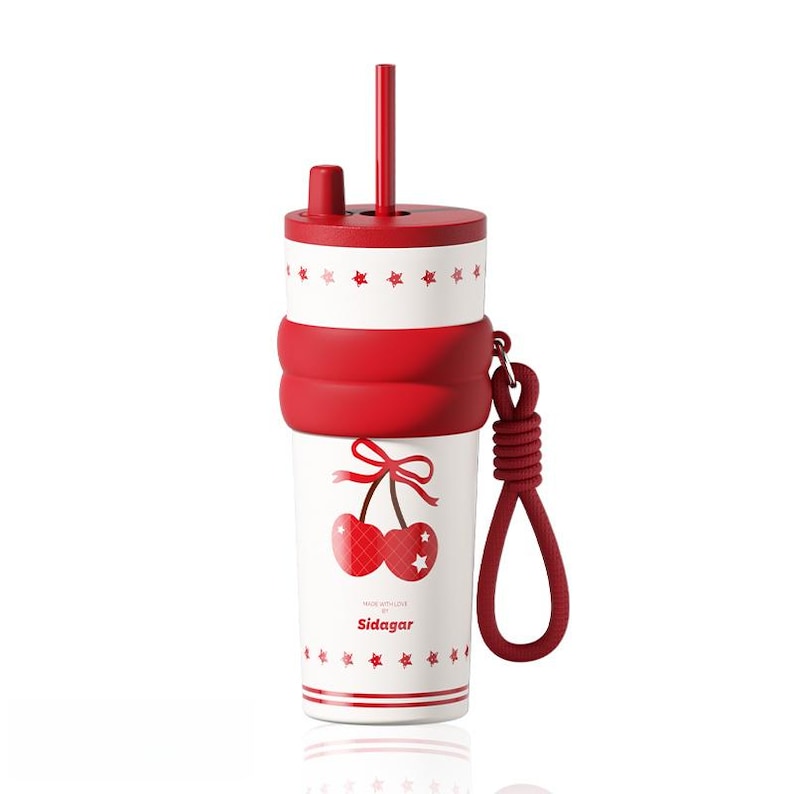 May include: A white tumbler with a red lid and straw, featuring a red cherry graphic with a bow, red star patterns, and a red silicone grip band. A red rope loop is attached to the side. The text Sidagar is printed in red on the front surface.