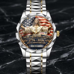 May include: A silver and gold wristwatch with a detailed face featuring an image of Jesus Christ with the American flag in the background. The watch face includes the text "I am the way the truth, and the life" and "1776-2026 250th Anniversary".