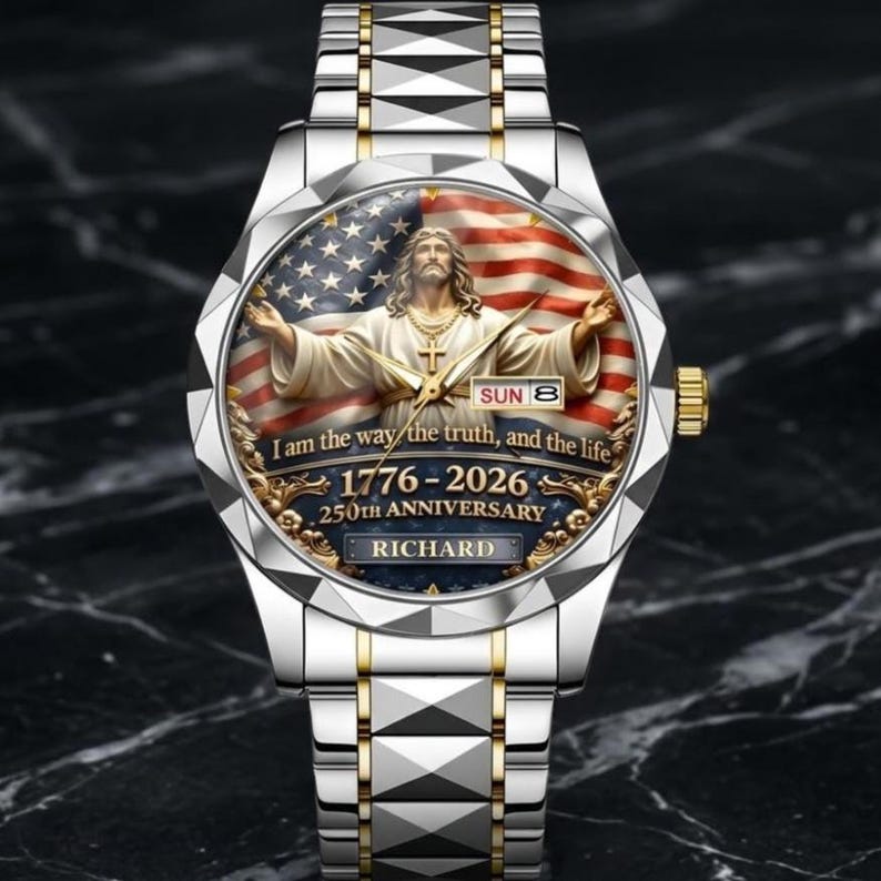 May include: A silver and gold wristwatch with a detailed face featuring an image of Jesus Christ with the American flag in the background. The watch face includes the text "I am the way the truth, and the life" and "1776-2026 250th Anniversary".