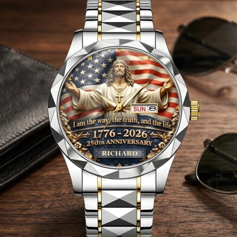 May include: A silver and gold wristwatch with a detailed face featuring an image of Jesus Christ with an American flag background. The watch face includes the text "I am the way, the truth, and the life" and "1776-2026 250th Anniversary".