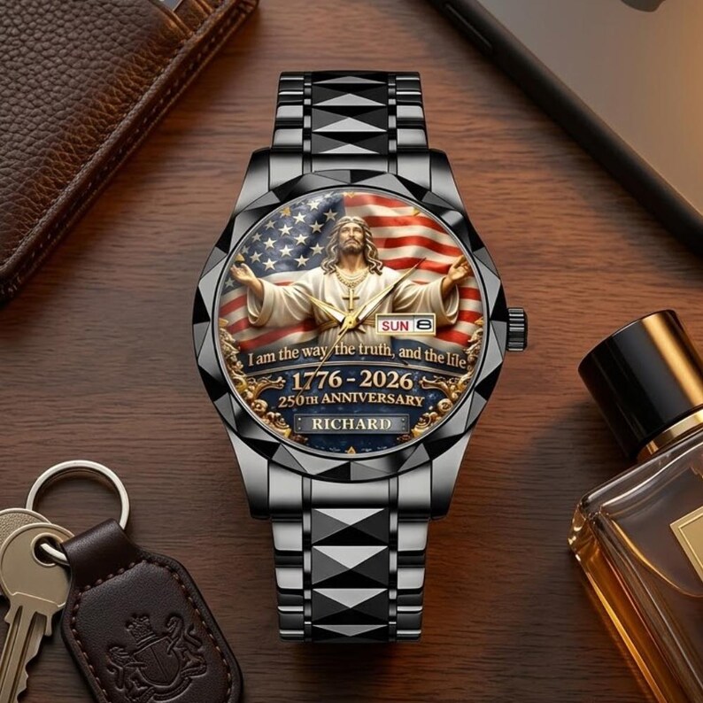 May include: A stainless steel watch with a detailed face featuring an image of Jesus Christ with an American flag background. The watch face includes the text "I am the way the truth, and the life" and "1776-2026 250th Anniversary RICHARD". The watch has a black strap.