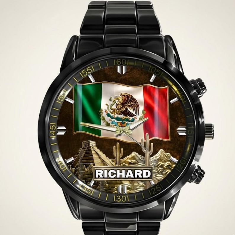 May include: Black wristwatch featuring the Mexican flag on the watch face, with the name "RICHARD" below. The watch face also includes images of a pyramid, cacti, and mountains. The watch has a black metal band.