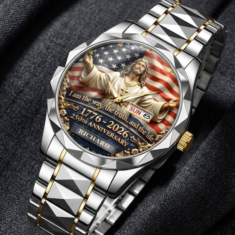 May include: Silver and gold-toned wristwatch with a detailed face featuring an image of Jesus with the American flag. The watch face includes the text "I am the way, the truth, and the life" and "1776-2026 250th Anniversary".