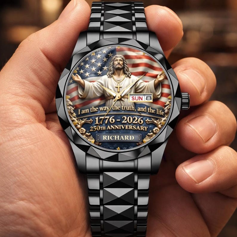 May include: Black wristwatch with a detailed face featuring an image of Jesus with the American flag in the background. The watch face includes the text "I am the way the truth, and the life" and "1776-2026 250th Anniversary". The watch band is black.