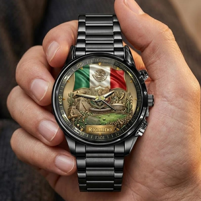 May include: Black wristwatch with a detailed face featuring the Mexican flag and a landscape scene. The watch has a black metal strap and the name "Ricardo" is printed on the watch face.
