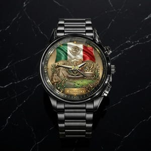 May include: A black wristwatch with a detailed face featuring the Mexican flag in green, white, and red. The watch face also displays a detailed illustration of a landscape. The watch band is made of black metal and the word "Ricardo" is printed on the watch face.