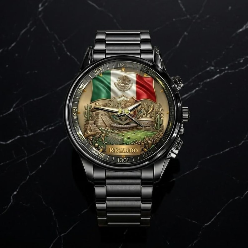 May include: A black wristwatch with a detailed face featuring the Mexican flag in green, white, and red. The watch face also displays a detailed illustration of a landscape. The watch band is made of black metal and the word "Ricardo" is printed on the watch face.