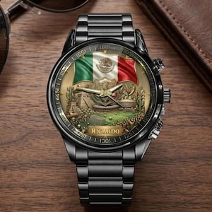 May include: Black wristwatch with a detailed face featuring the Mexican flag in green, white, and red. The watch face also includes a stadium scene and the name "Ricardo". The watch has a black metal strap and a round face.