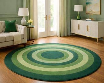 May include: A round rug with concentric circles in shades of green, from dark to light. The rug is on a hardwood floor in a room with a sofa, side table, and a white cabinet. The room has green walls and curtains.
