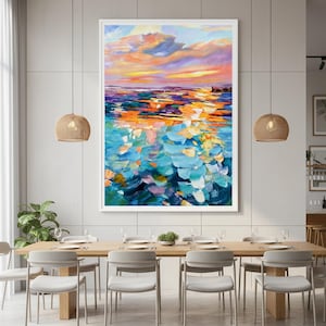 May include: Large framed abstract painting of a sunset over water. The artwork uses vibrant brushstrokes of orange, blue, and purple, creating a textured and dynamic visual effect. The painting is displayed in a modern dining room setting.