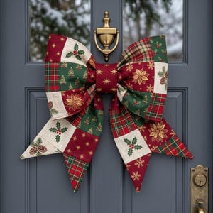 May include: A large fabric bow featuring a patchwork design of red, green, and cream squares. The pattern includes printed motifs of Christmas trees, poinsettias, holly leaves, pinecones, and gold stars. The bow is attached to a brass door knocker.