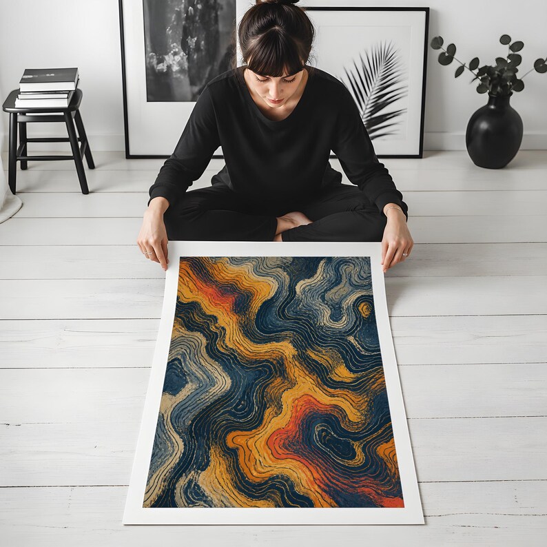 May include: A rectangular art print featuring an abstract design of swirling, fluid lines in shades of deep navy blue, golden yellow, and burnt orange. The composition mimics topographical patterns with dense, concentric, and wavy textures.