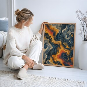 May include: A rectangular framed wall art piece featuring an abstract design of flowing, wavy lines in shades of deep navy blue, golden yellow, and burnt orange, set within a light-toned wooden frame that highlights the textured, layered pattern.