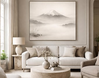May include: A living room scene featuring a large landscape painting of a snow-capped mountain over a lake. The room includes a white sofa, beige armchairs, a round coffee table, and a table lamp. The color palette is neutral with beige and cream tones.