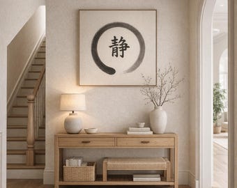 May include: A well-lit entryway with a wooden console table, a woven bench, and a framed artwork featuring a black circle and a Japanese character. The text "Quiet the Noise" is above the artwork. A staircase and a vase with branches are also visible.
