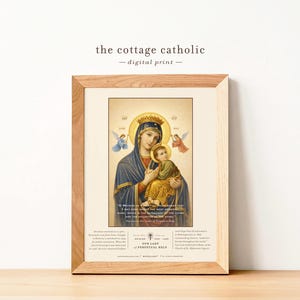 May include: A framed digital print featuring a religious image of the Virgin Mary holding baby Jesus, with angels on either side. The print has a gold halo and crown. The text "the cottage catholic - digital print" is at the top.
