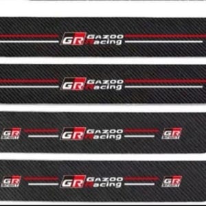 May include: Four black car door sill protectors with a carbon fiber texture. Each protector features the "GR GAZOO Racing" logo in red and white. The number "4PCS" is displayed in red.
